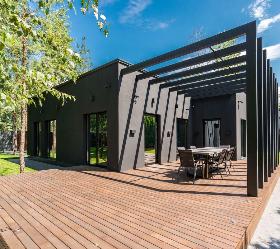 Timber deck and pergola opening onto a green yard